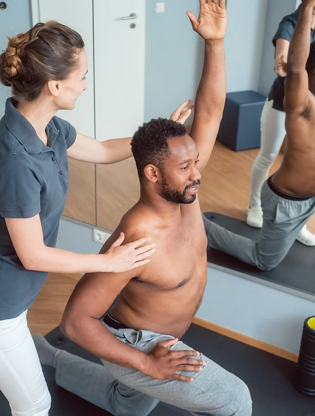 A physiotherapist helping their patient